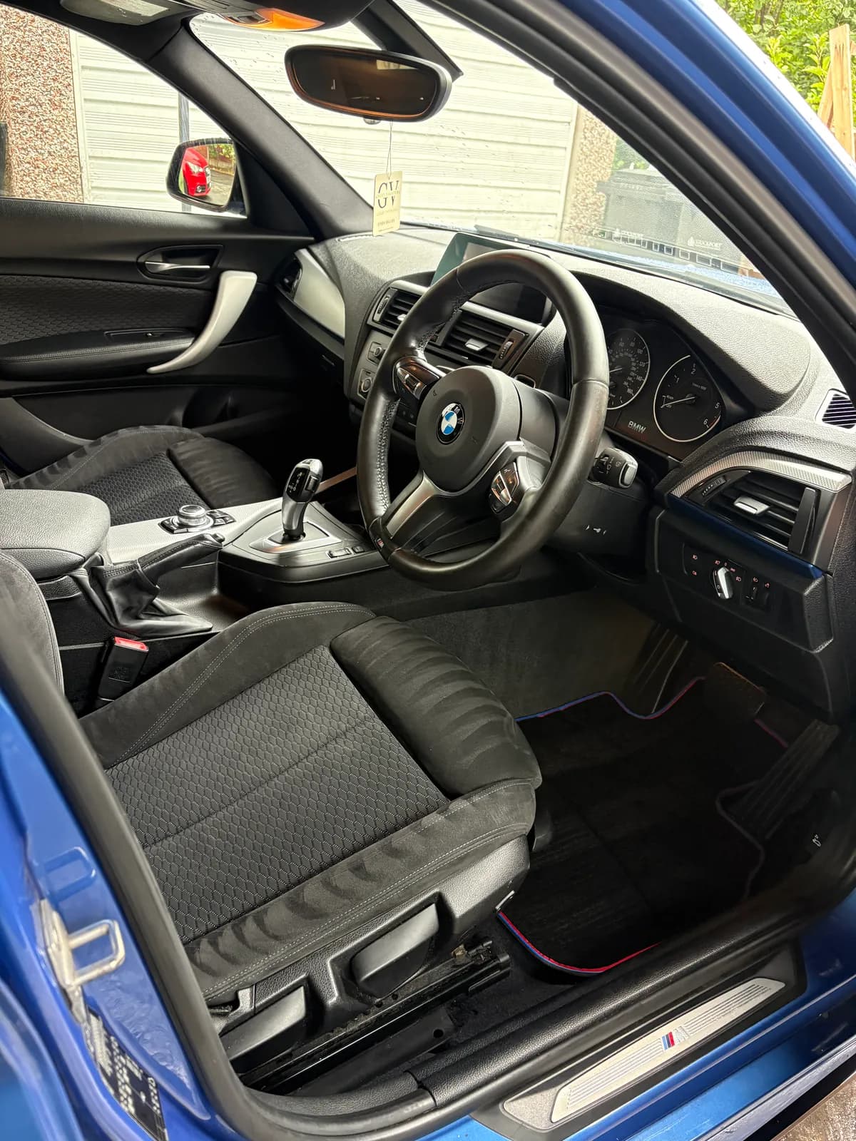 Blue BMW driver seat and footwell after interior cleaning