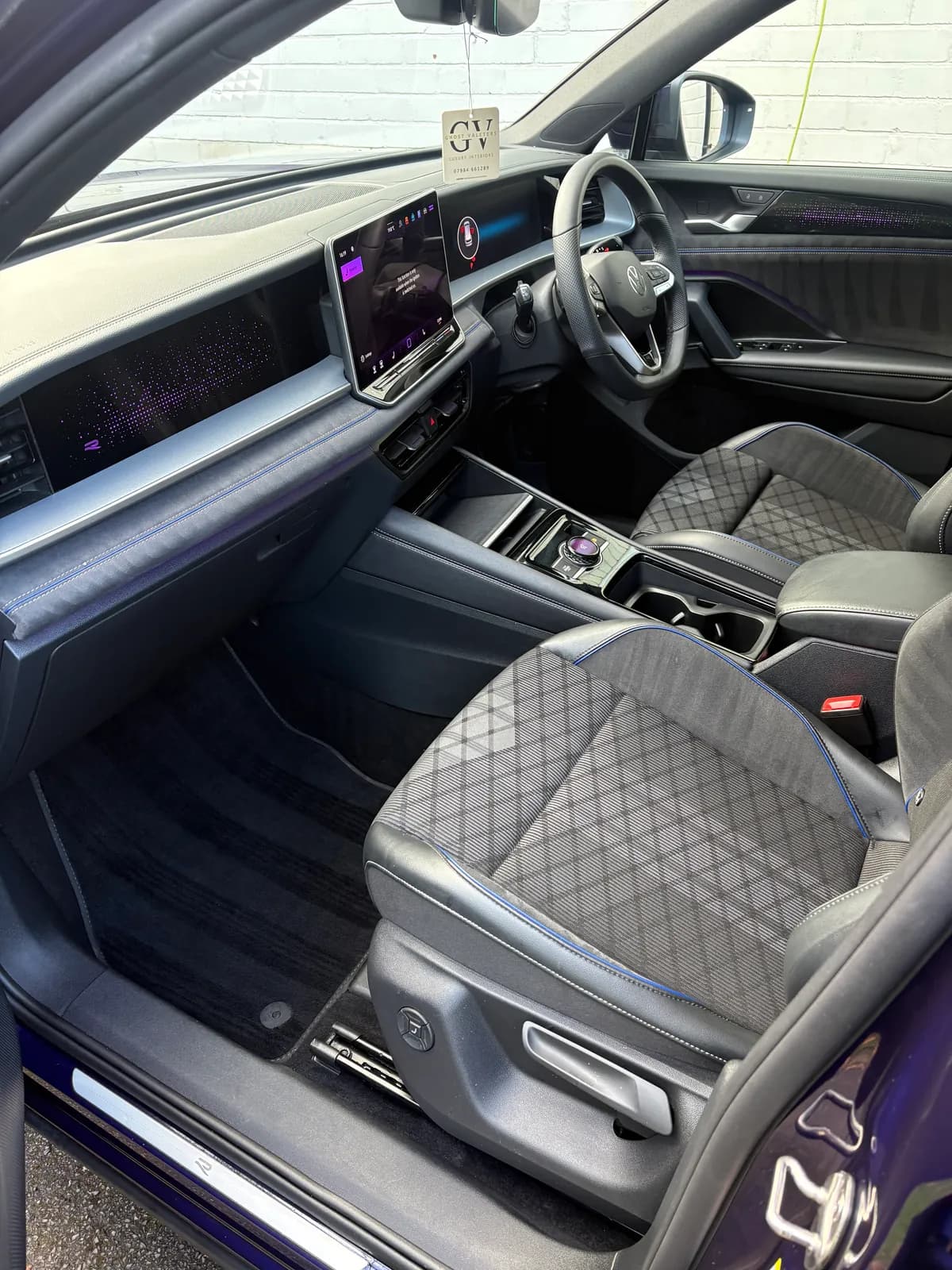 Blue SUV front seat and footwell after interior cleaning