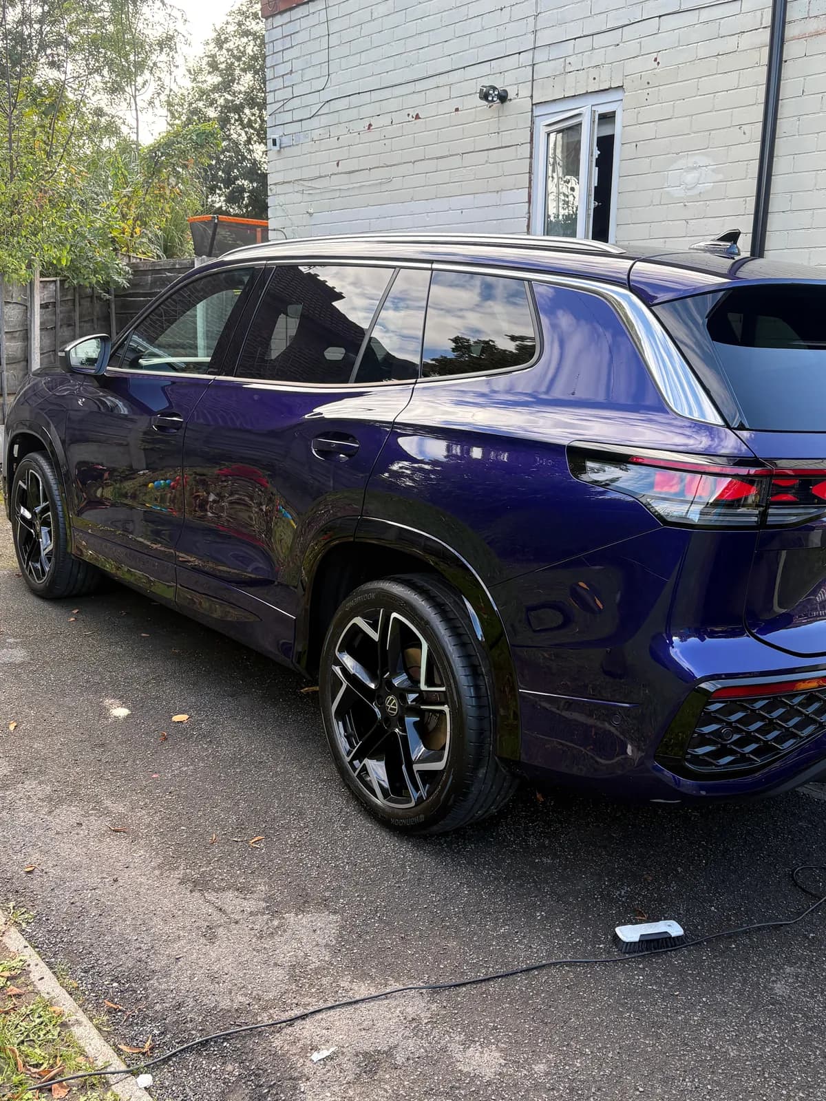 Blue SUV viewed from the rear quarter