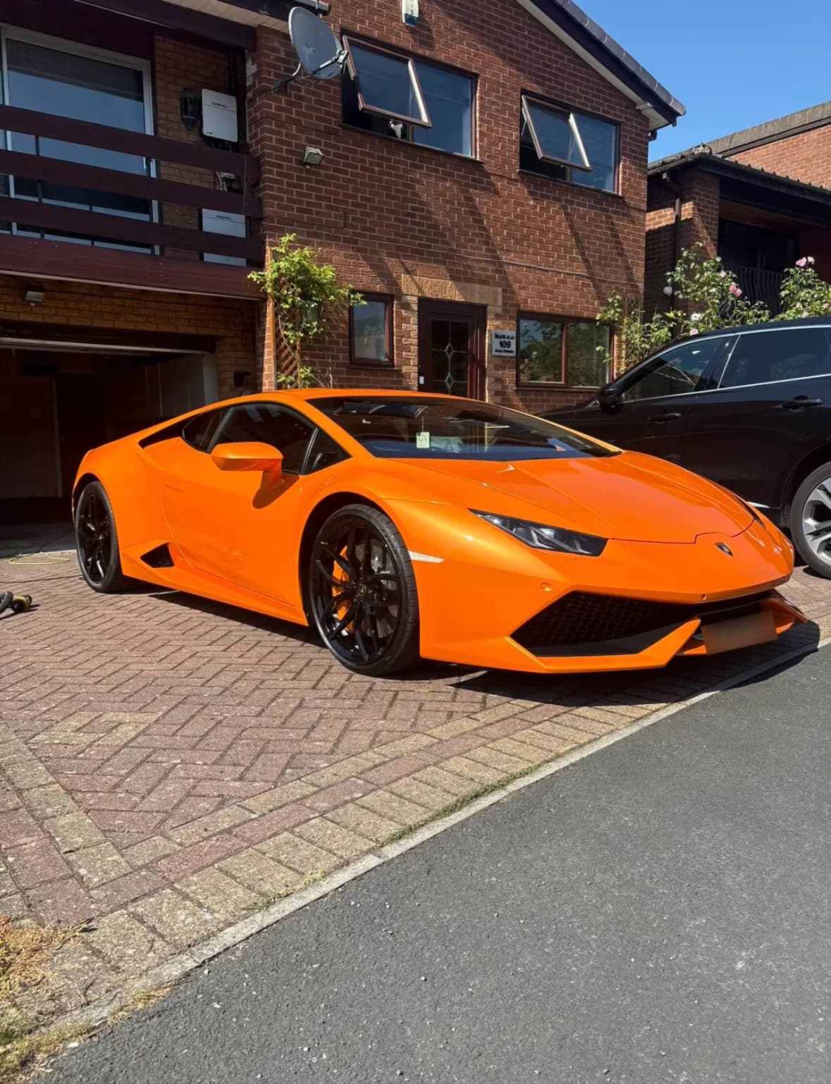 Orange Lamborghini Huracán on a driveway