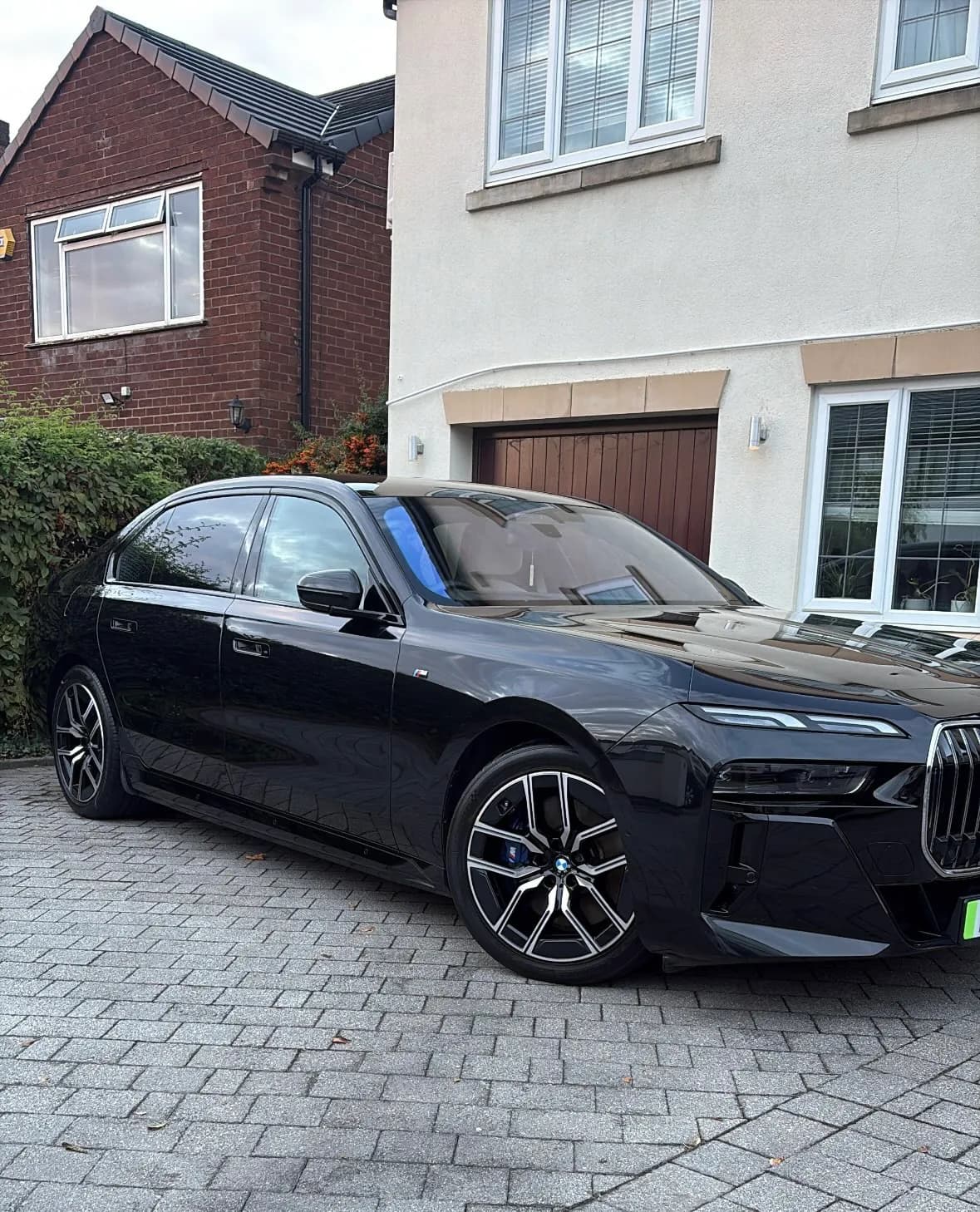 Black BMW saloon on a driveway